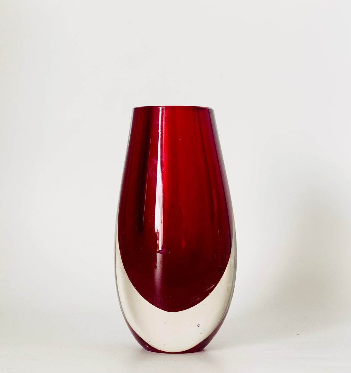 A Murano Sommerso vase cased in cranberry red and clear glass.