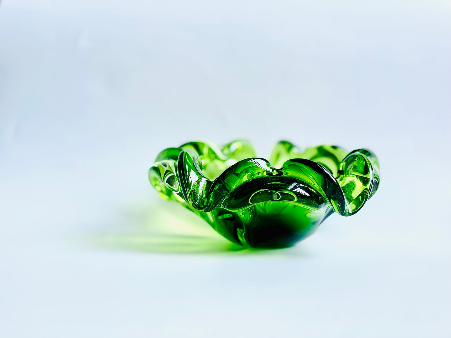 A Josef Hospodska Czech glass bowl in pea green .