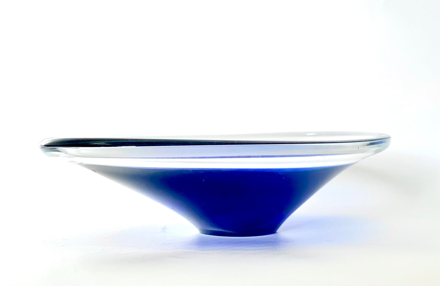 A clear and deep indigo blue cased art glass bowl.