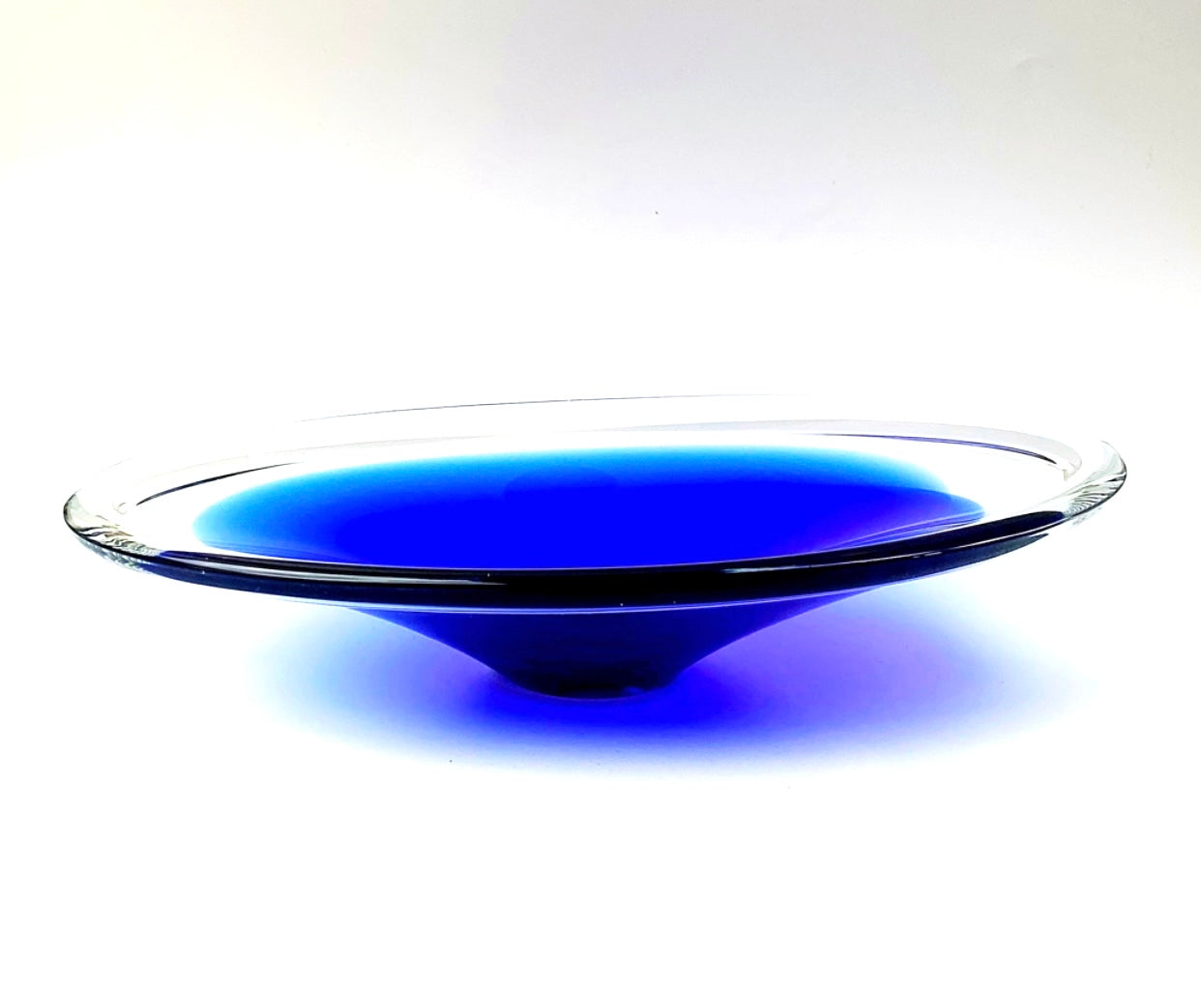 A clear and deep indigo blue cased art glass bowl.