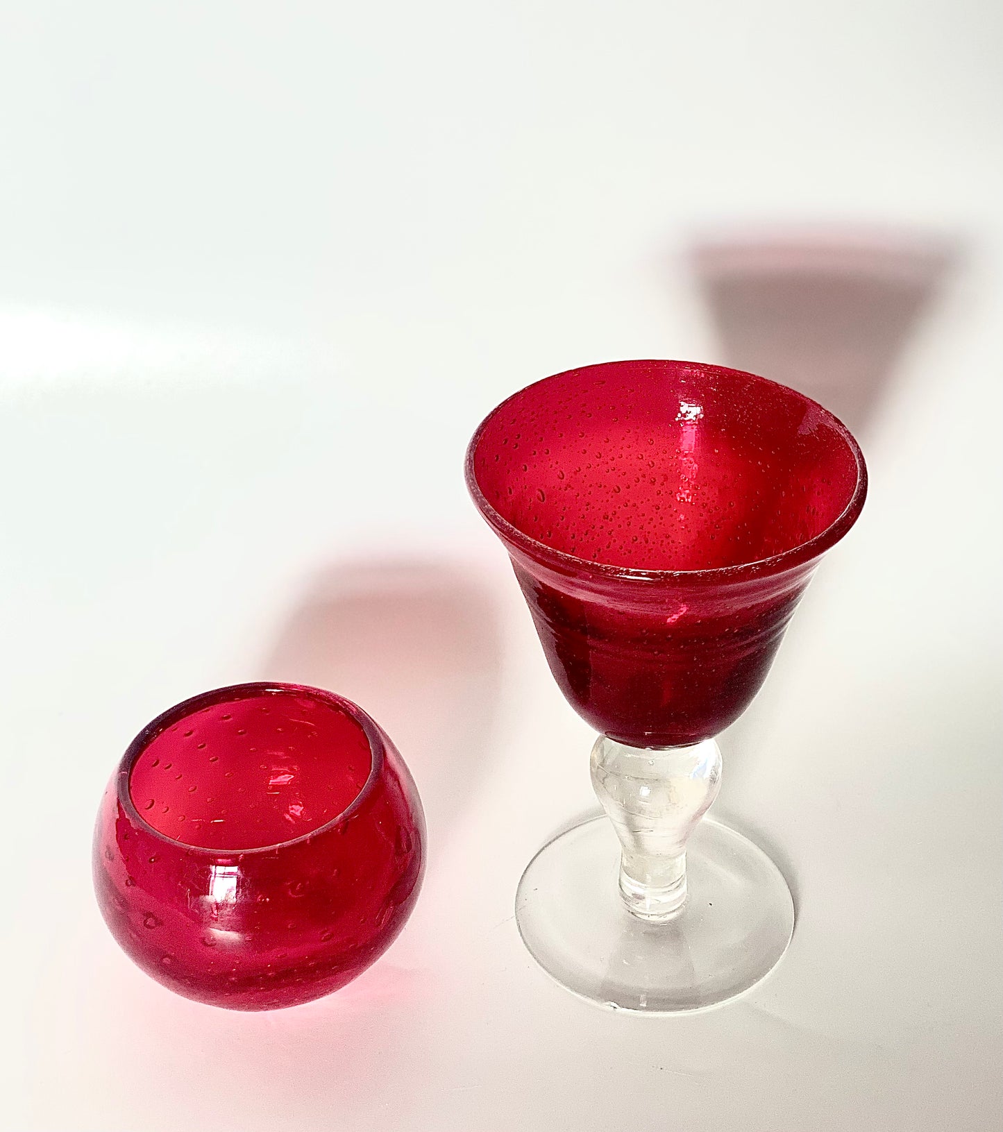 A Murano cranberry glass goblet and a bowl.