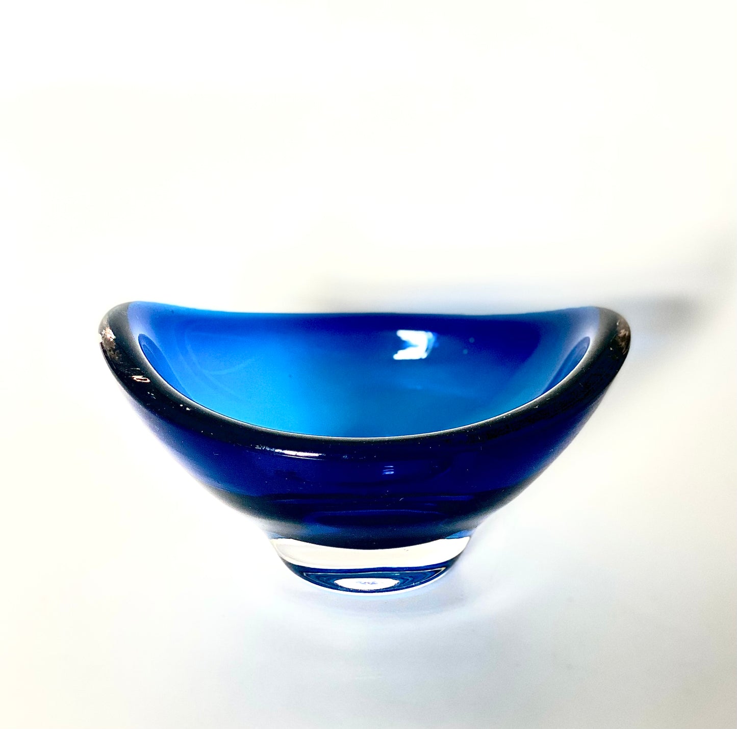 A Whitefriars boat shaped glass bowl in a deep indigo blue.