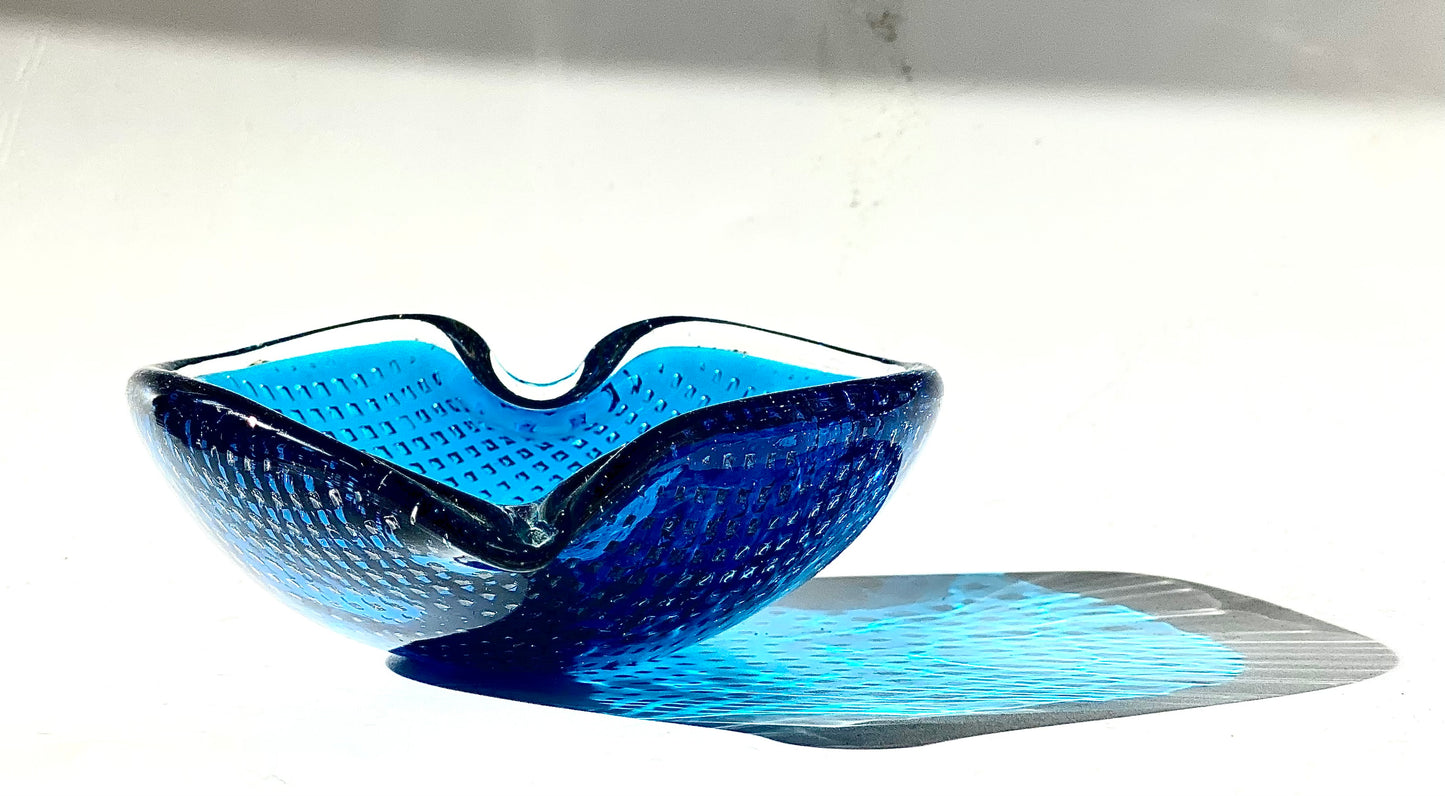 A Murano Bullicante glass bowl in sapphire blue in the shape of a heart.