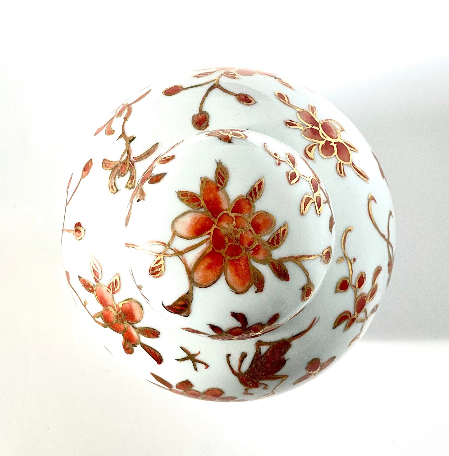 A Ginger jar. With gold gilding and orange flowery designs.