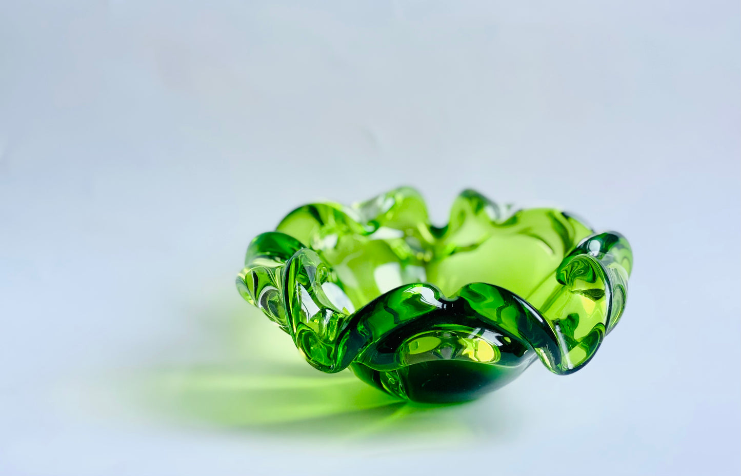 A Josef Hospodska Czech glass bowl in pea green .