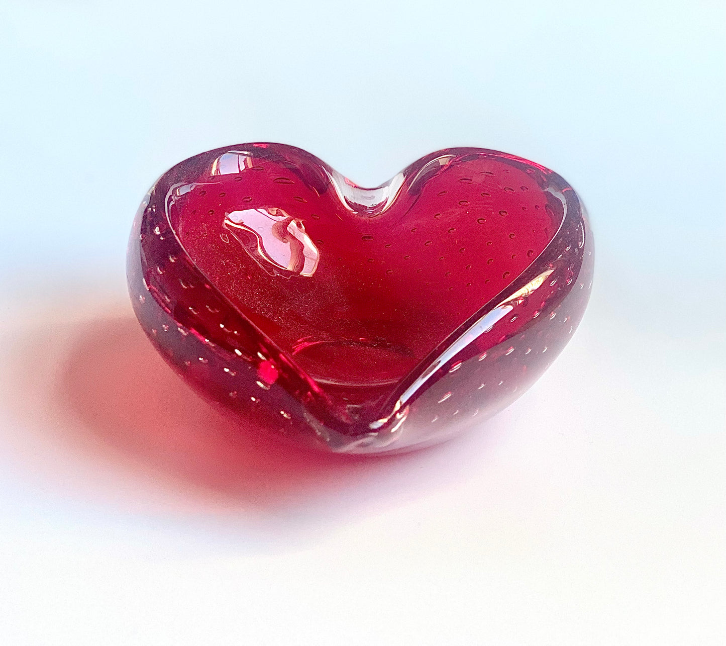 A Murano deep cherry red glass heart bowl .