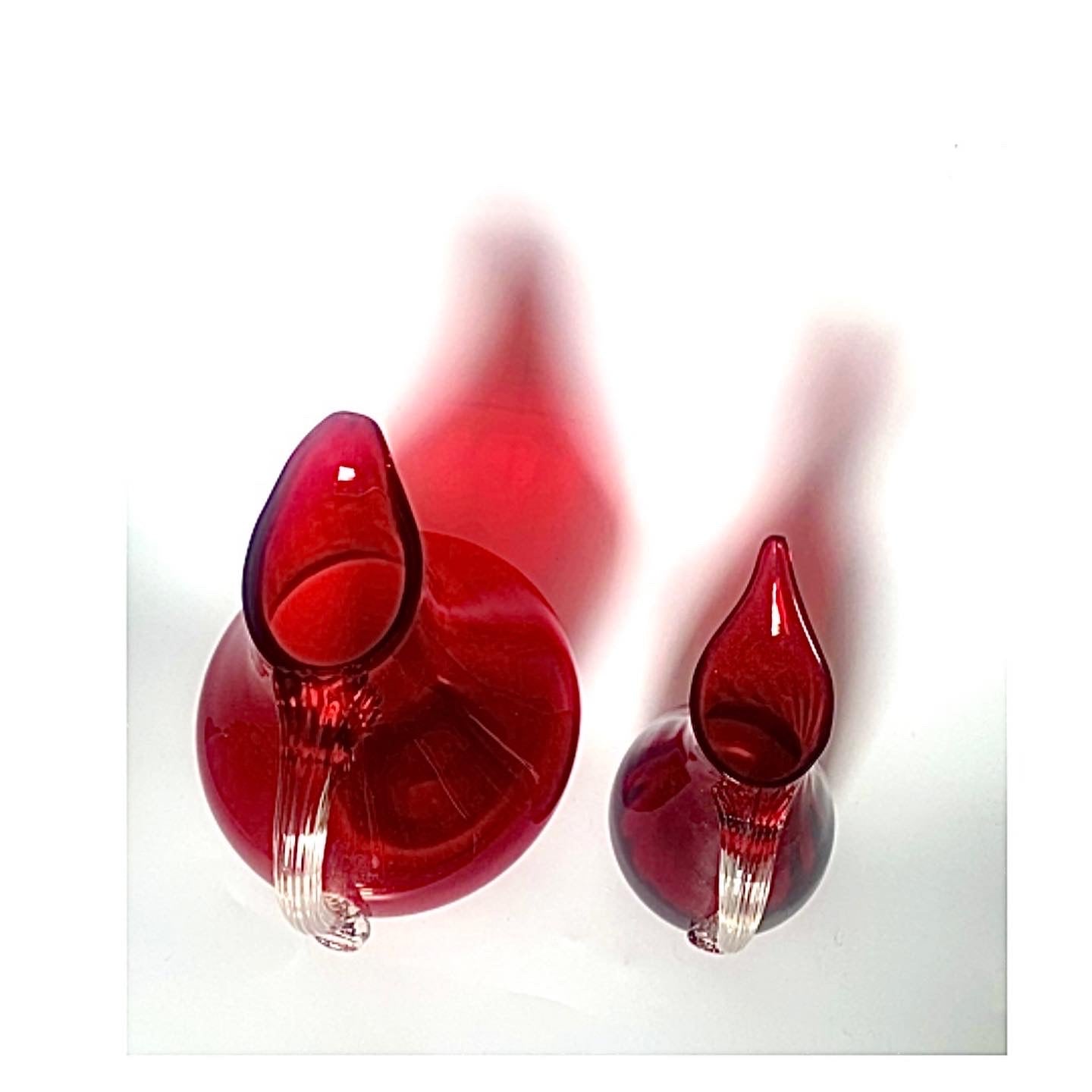 A handsome pair of cranberry red glass jugs.