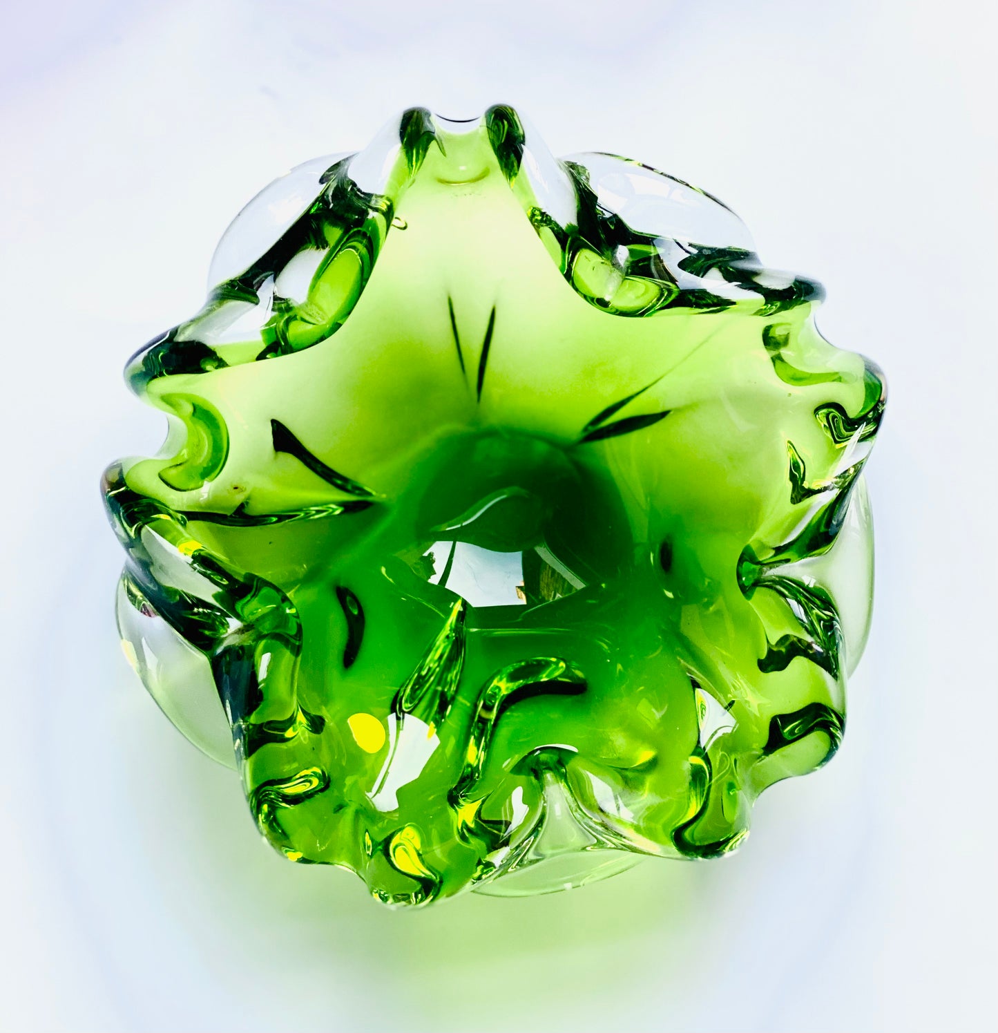 A Josef Hospodska Czech glass bowl in pea green .