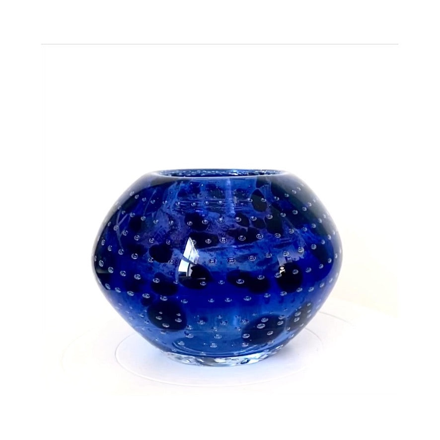 A Murano glass bowl in an inky deep violet with mottled flecks of black.