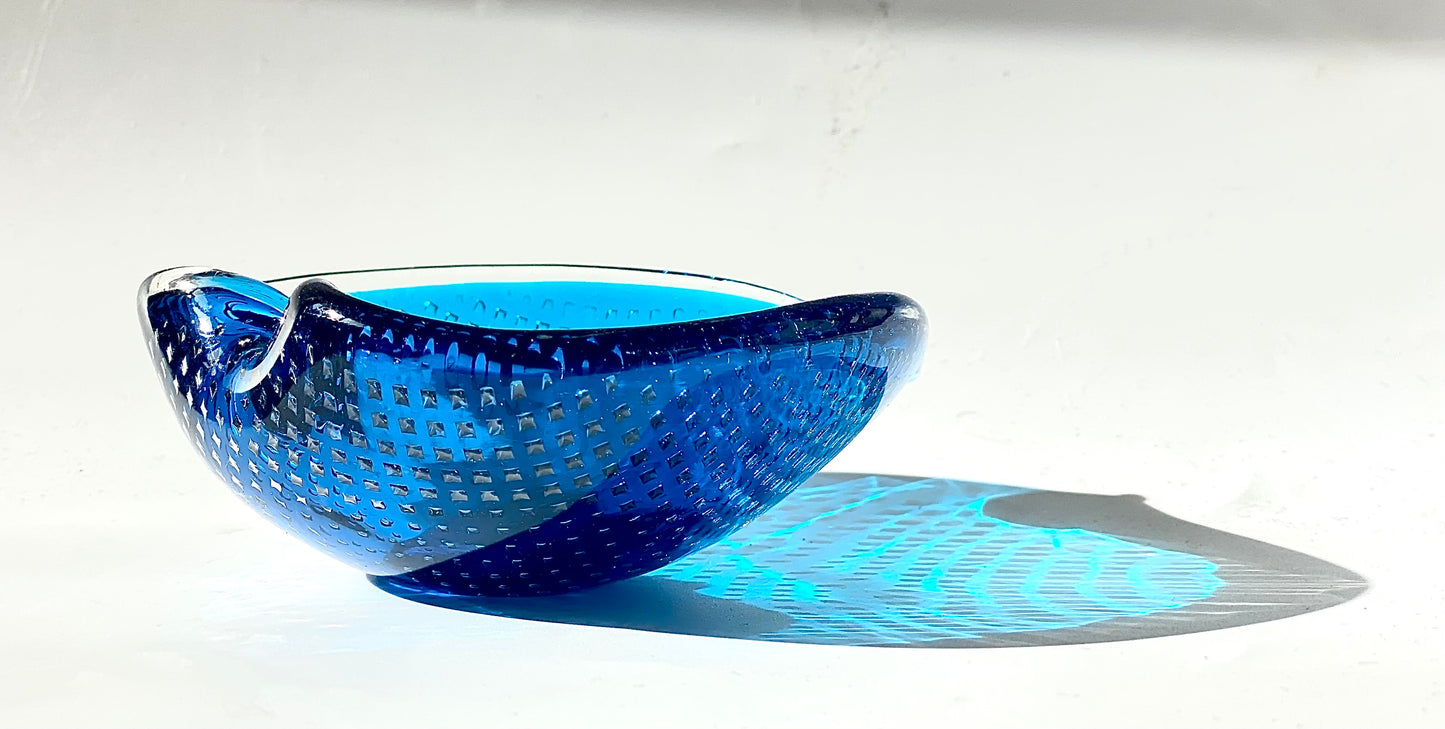 A Murano Bullicante glass bowl in sapphire blue in the shape of a heart.