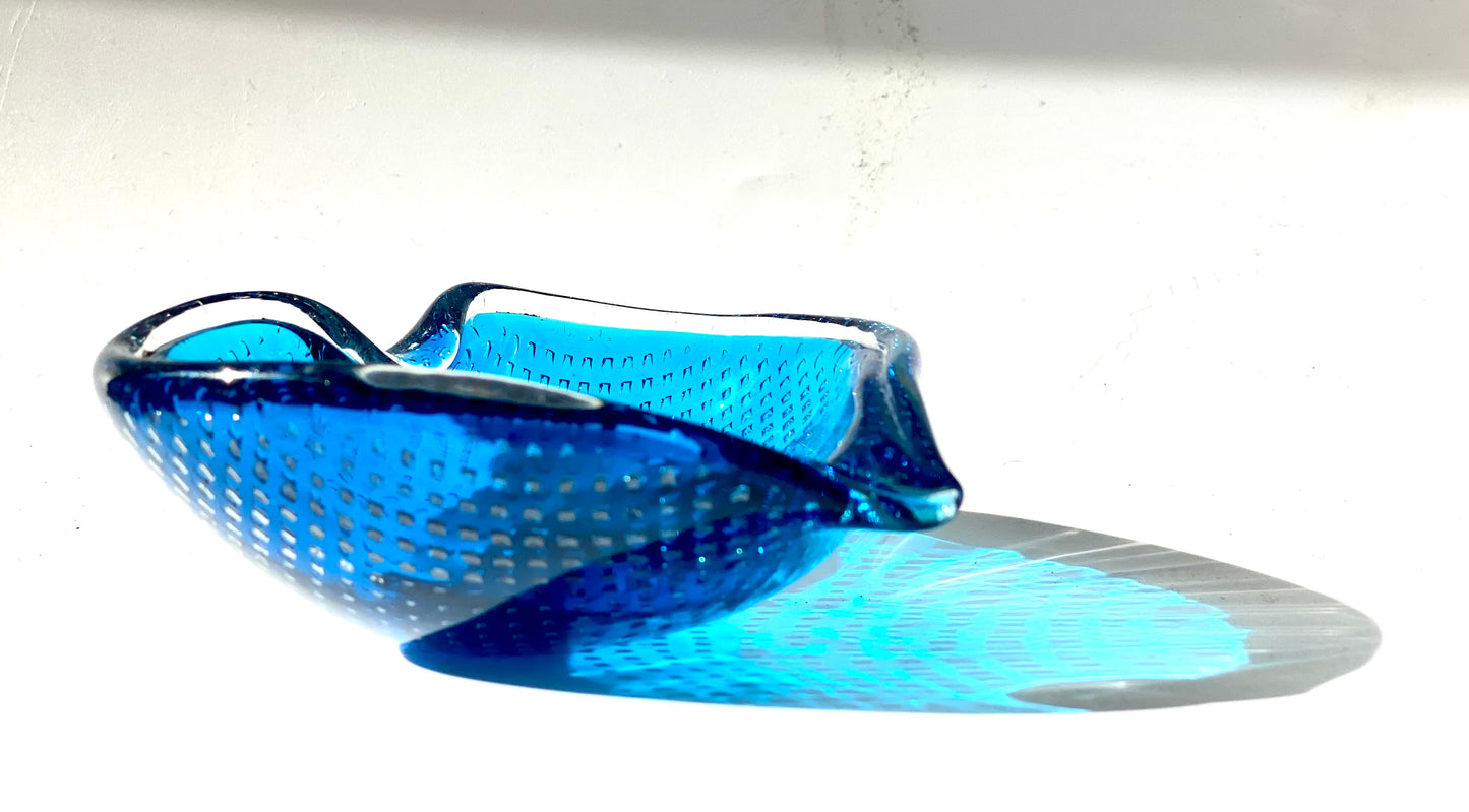 A Murano Bullicante glass bowl in sapphire blue in the shape of a heart.