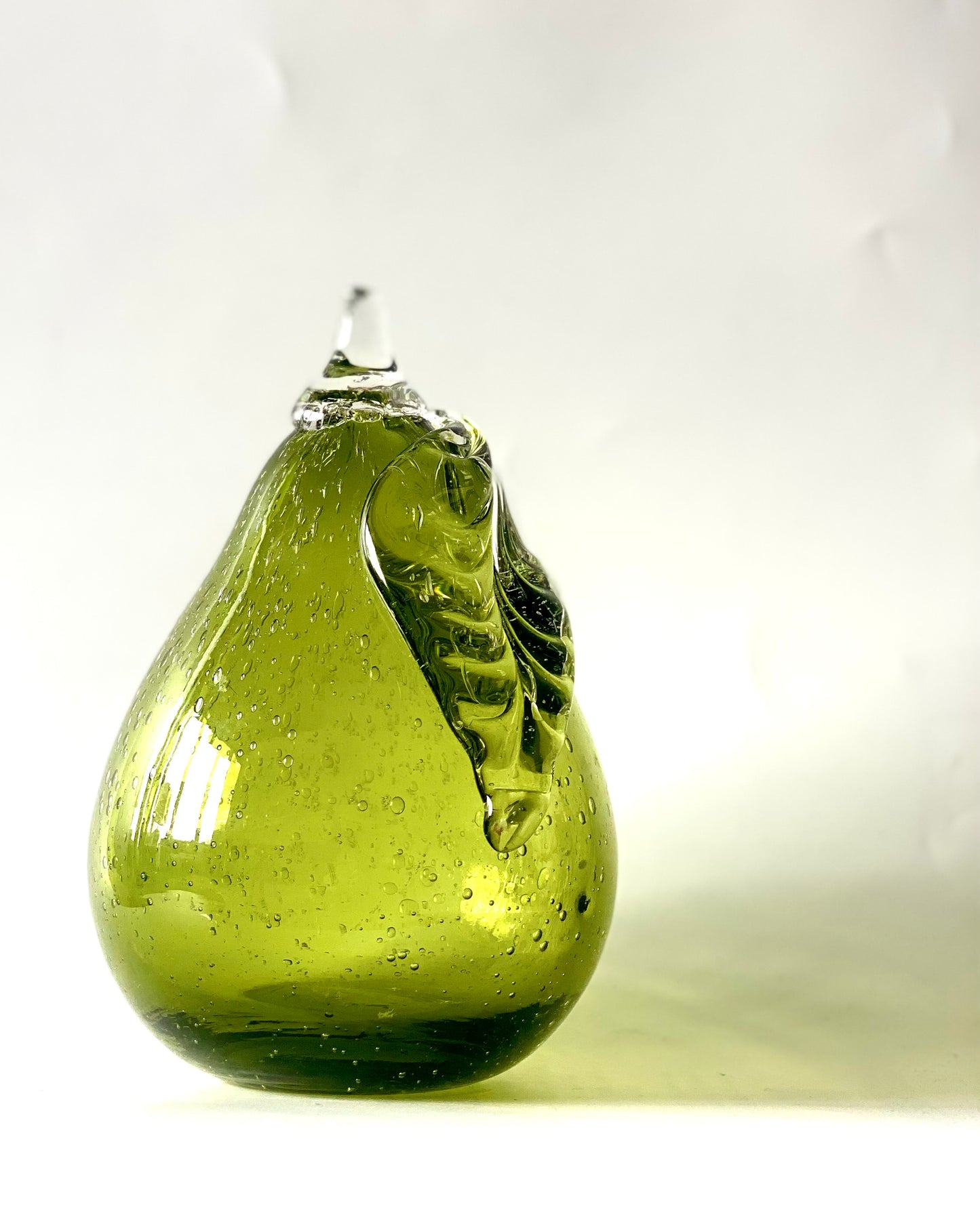 Lime green glass pear paperweight .