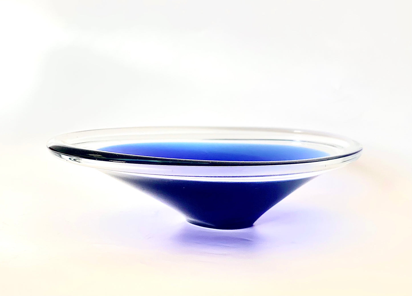 A clear and deep indigo blue cased art glass bowl.