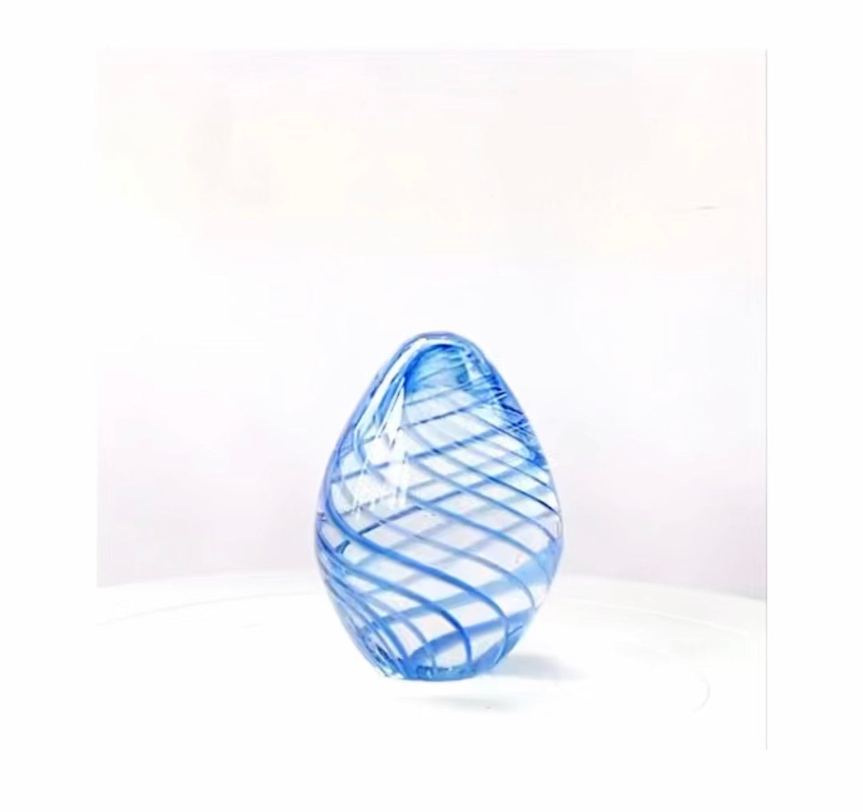 Glass paperweight with a royal blue and white swirl.