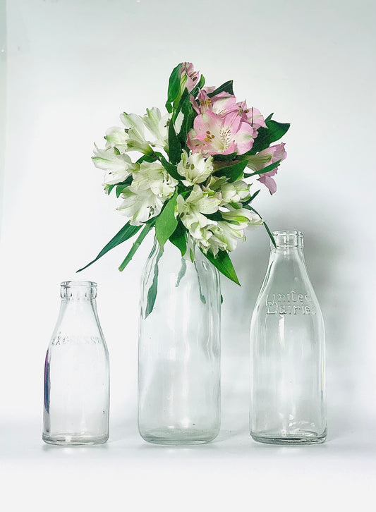 Original ‘ United Dairies ‘ & ‘ Dairies Express ‘ clear glass vintage milk bottles or vase or jug.