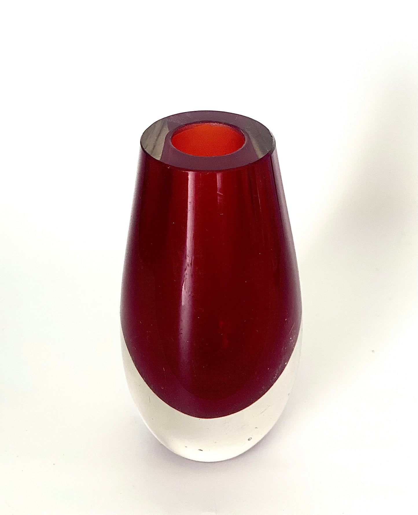 A Murano Sommerso vase cased in cranberry red and clear glass.