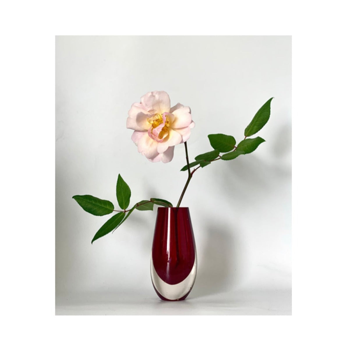 A Murano Sommerso vase cased in cranberry red and clear glass.