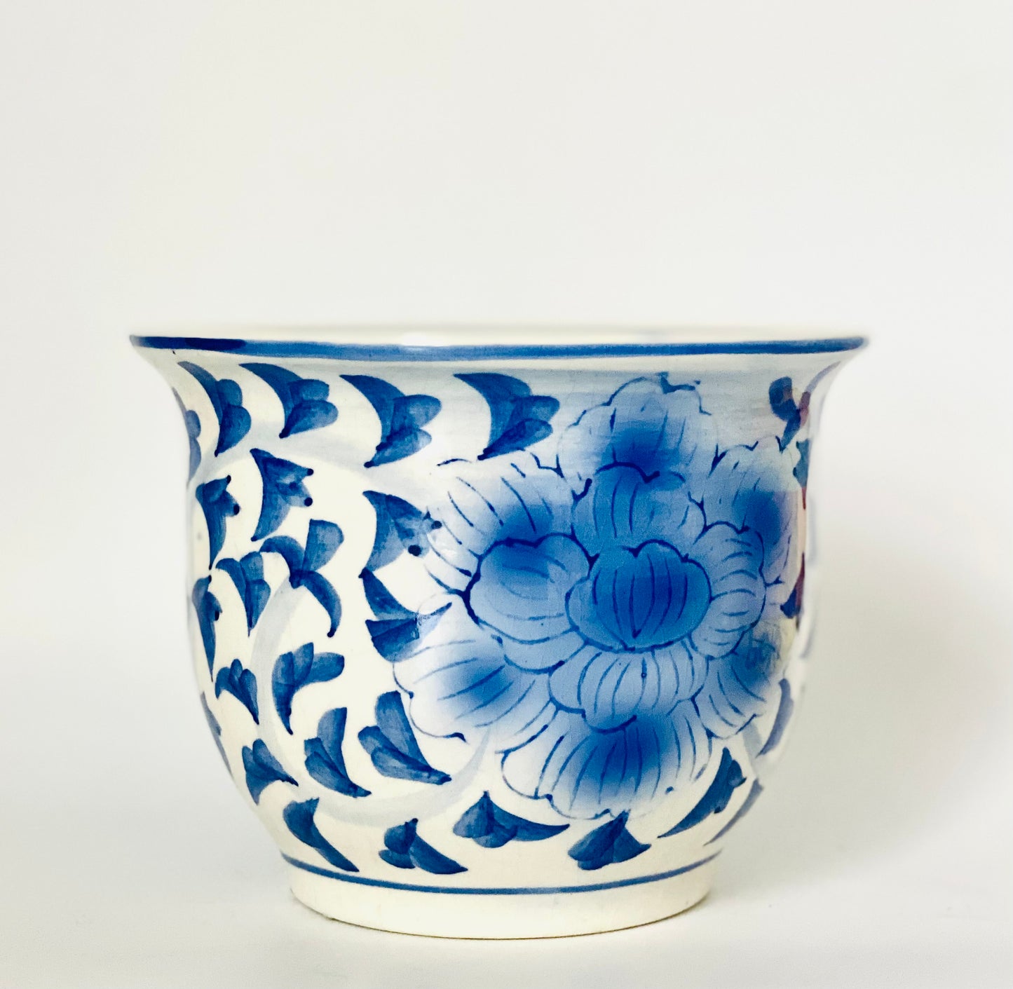 A blue and white handpainted ceramic flower pot planter.