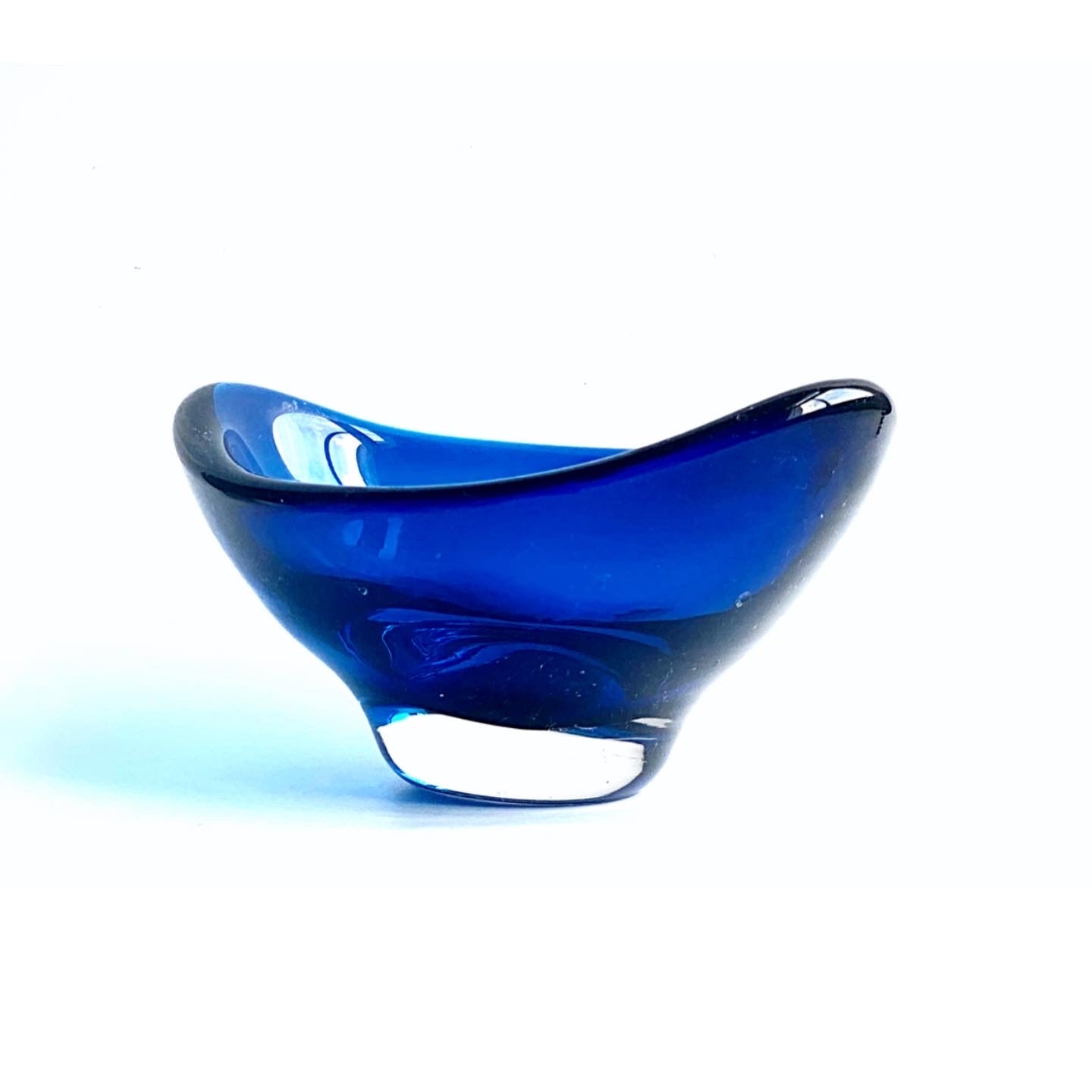 A Whitefriars boat shaped glass bowl in a deep indigo blue.