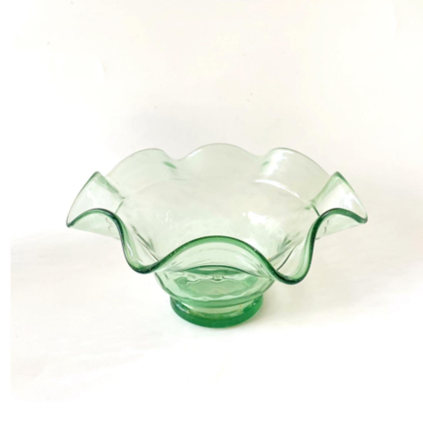 A set of 3 scalloped edged glass bowls in bottle green.