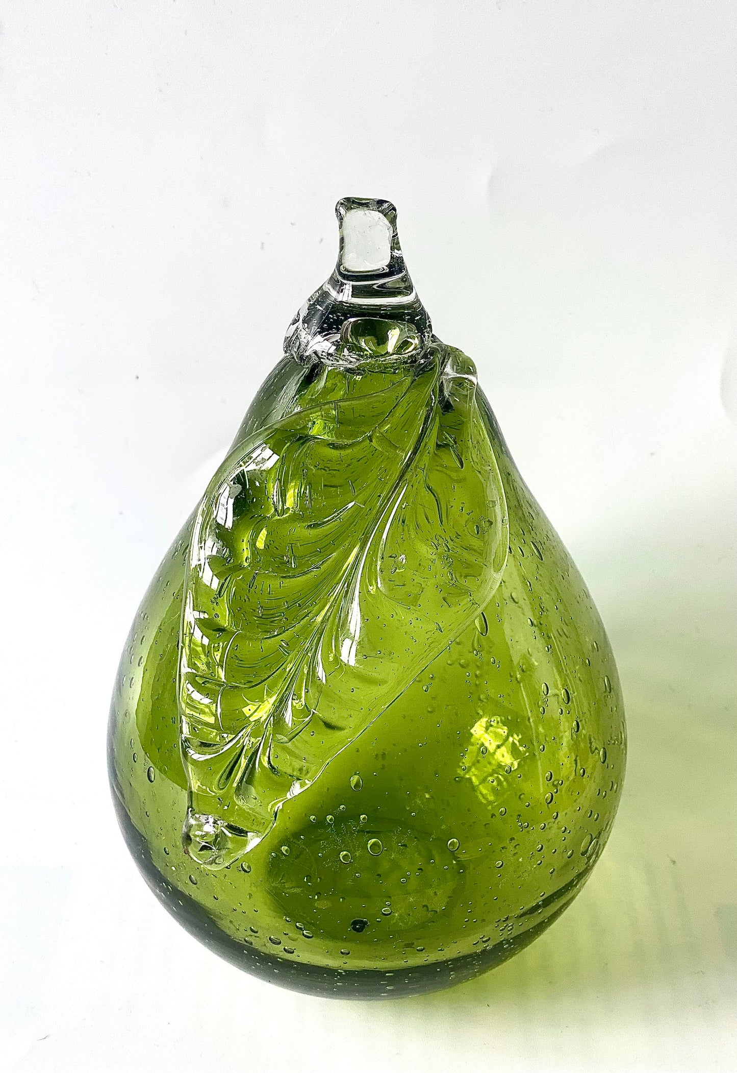 Lime green glass pear paperweight .