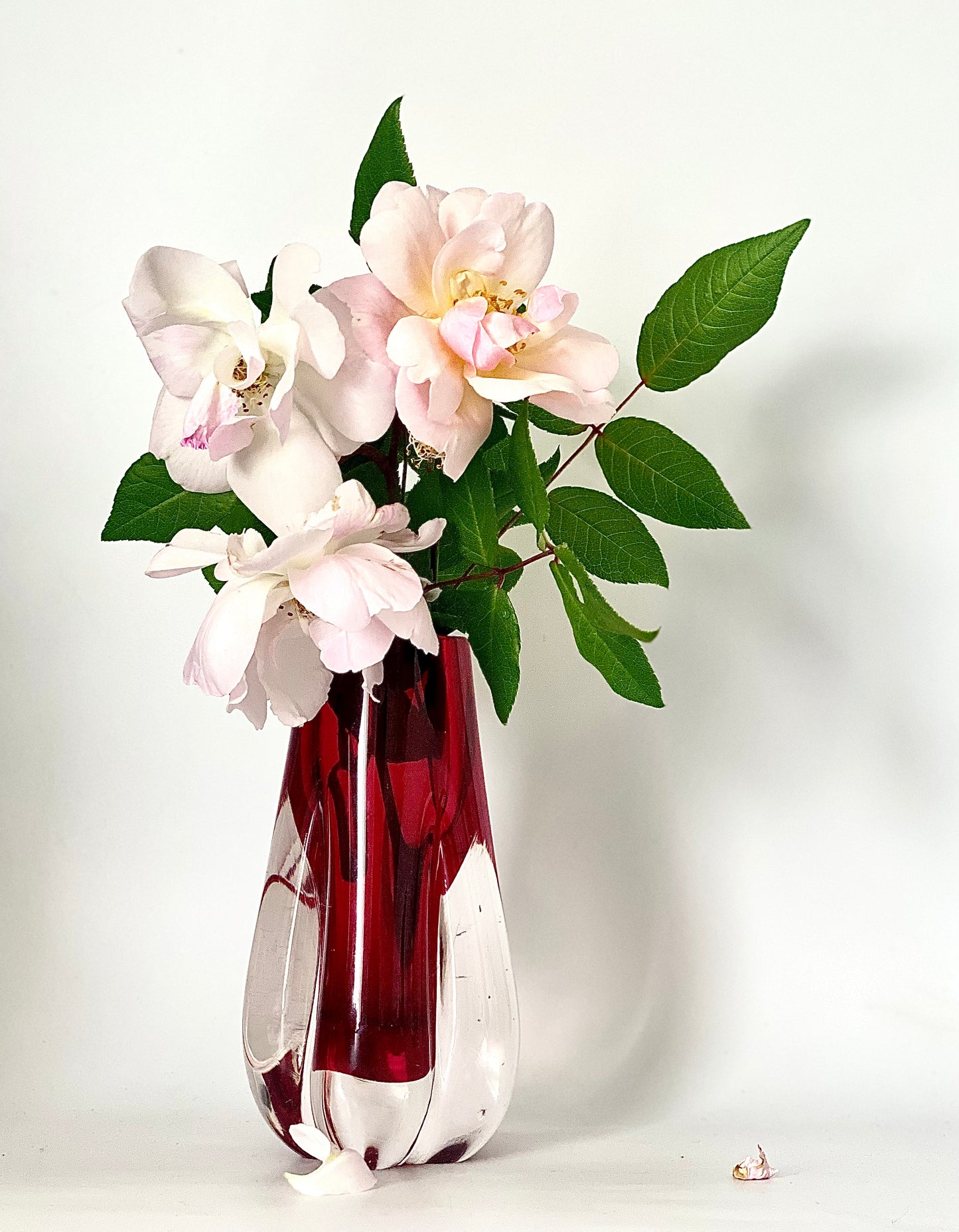 A Murano Sommerso vase cased in cranberry red and clear glass.