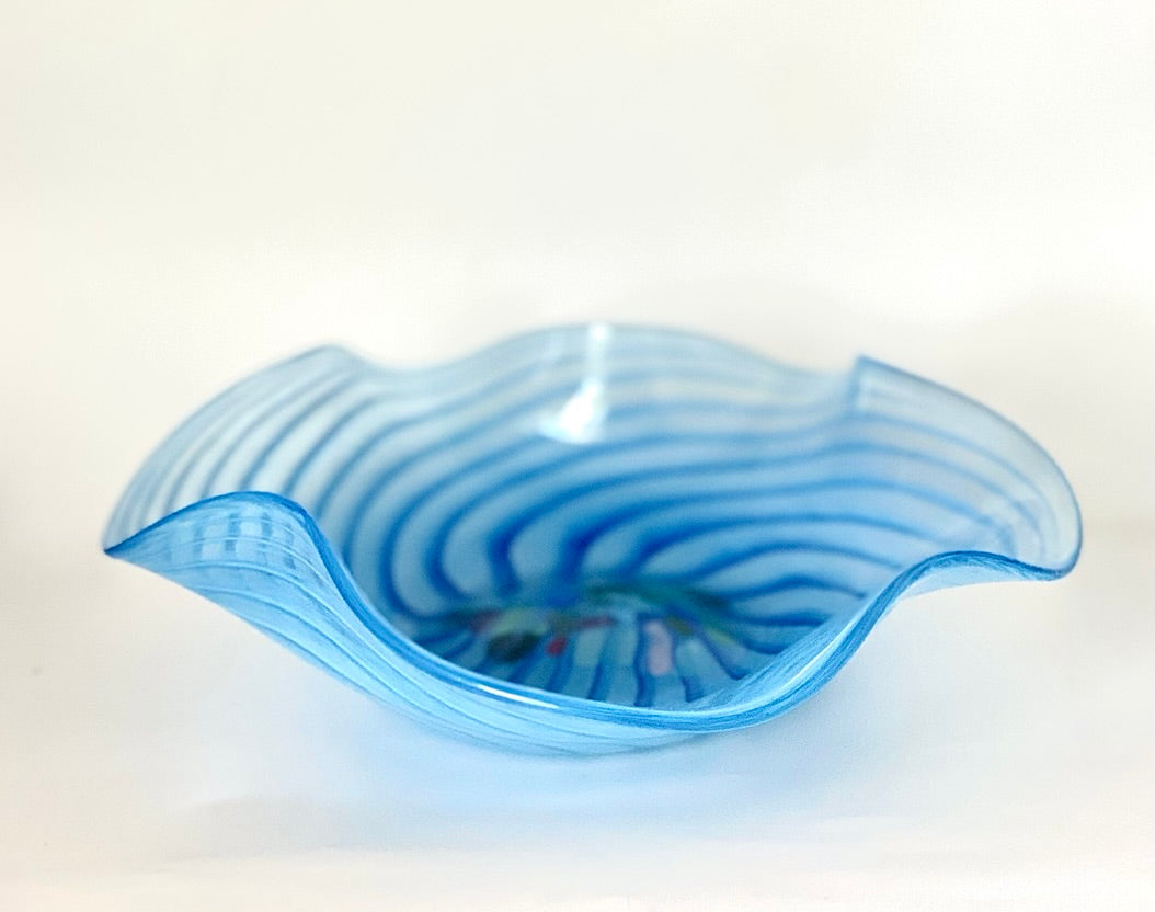 An unusual Murano glass bowl with a charming deep blue swirl and a cluster of pink,blue and green glass fragments in the centre.