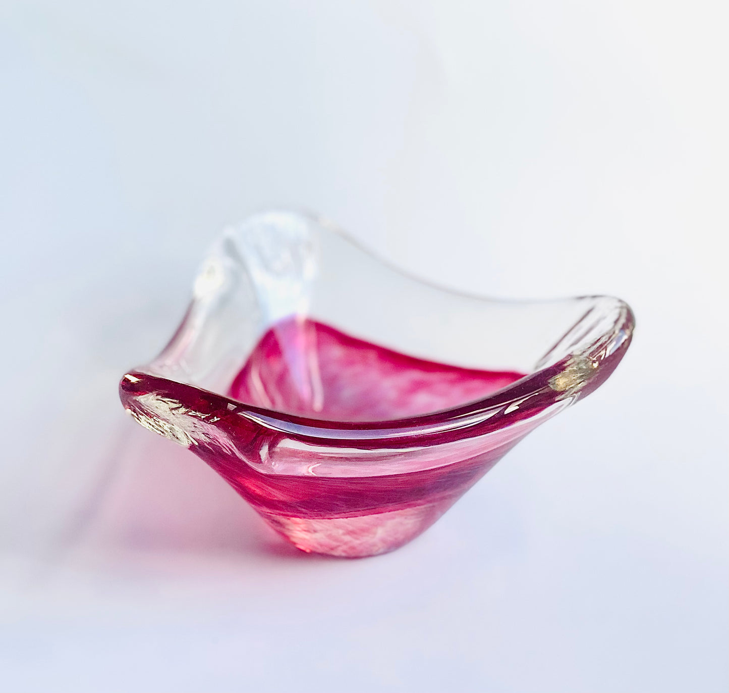 A glass bowl in a mottled fuscia pink.