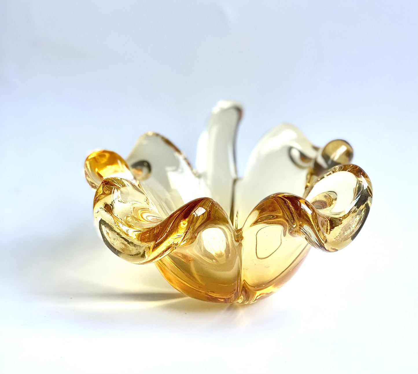 A Murano glass clover leaf bowl in a golden yellow