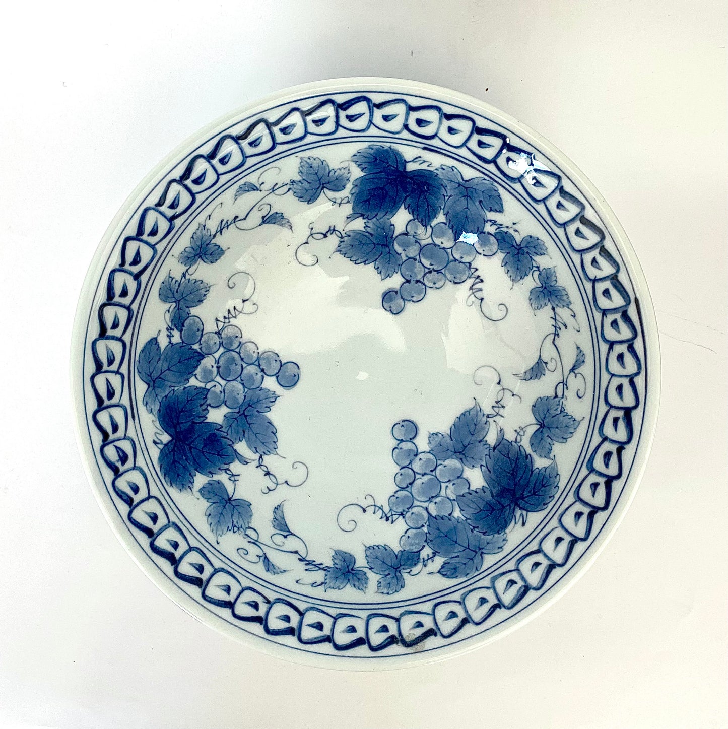 A charming set of blue and white ceramic bowls and a cup.