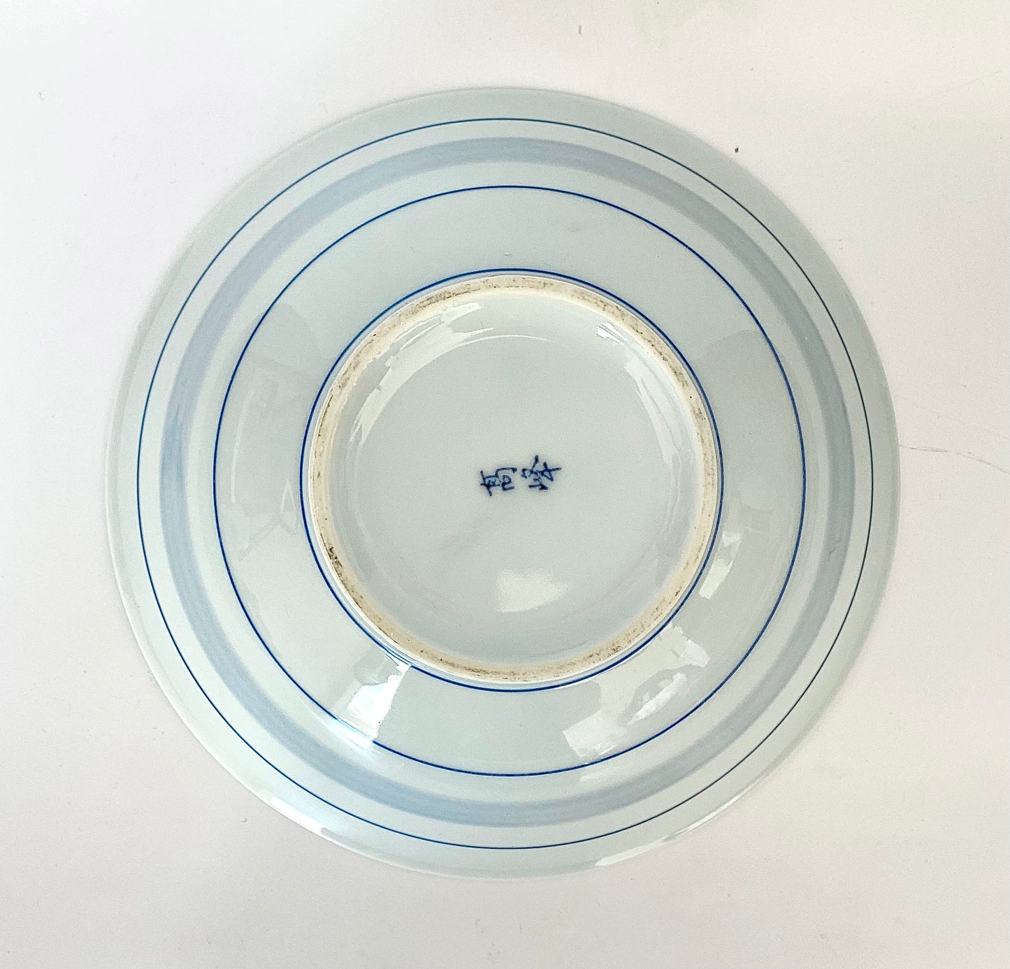 A charming set of blue and white ceramic bowls and a cup.