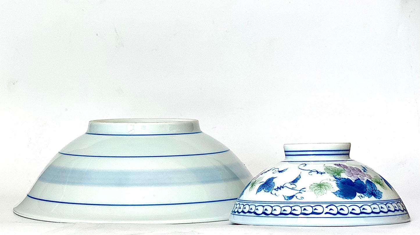 A charming set of blue and white ceramic bowls and a cup.