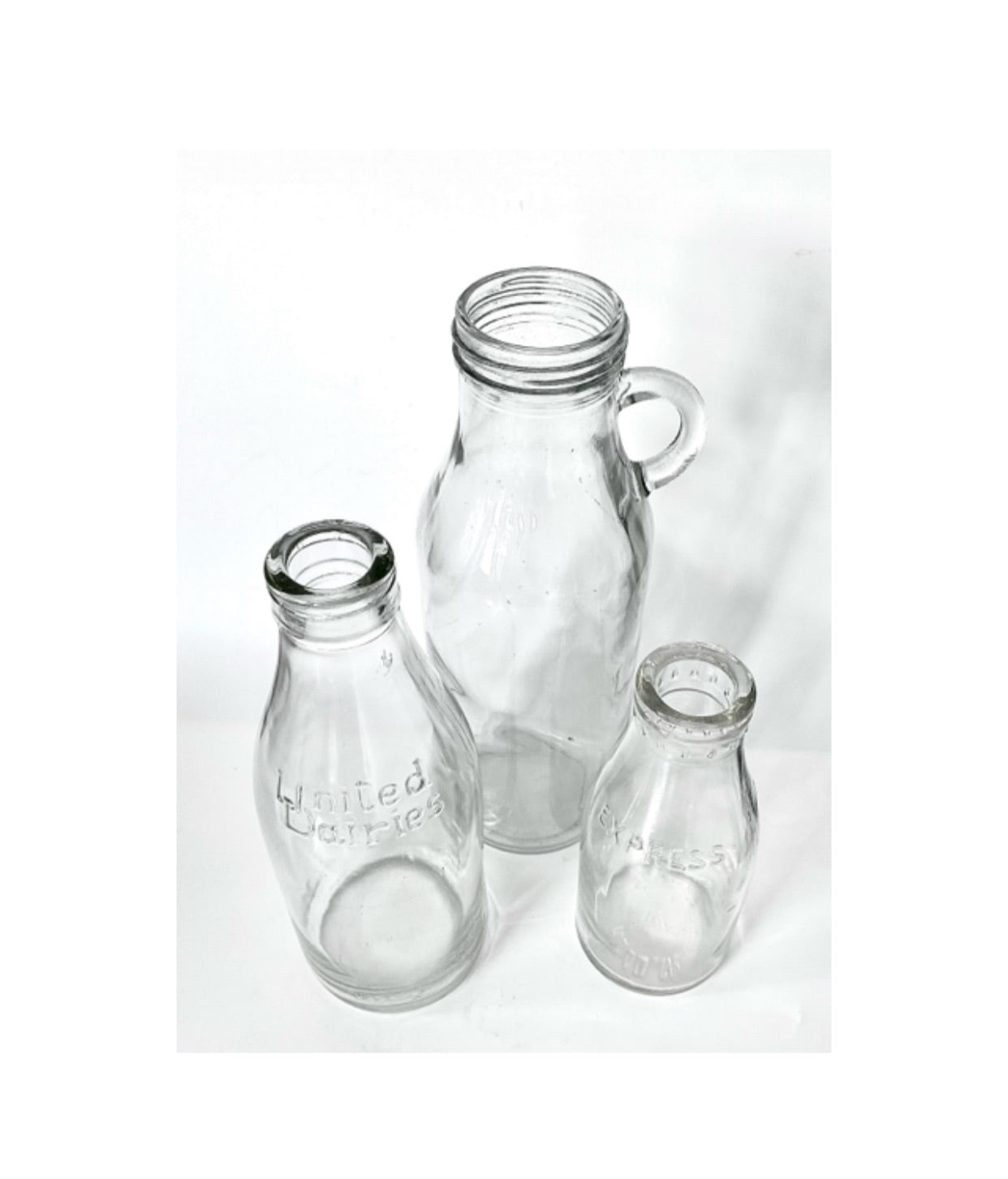 Original ‘ United Dairies ‘ & ‘ Dairies Express ‘ clear glass vintage milk bottles or vase or jug.