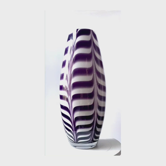 Studio art glass vase in a deep purple swirl.