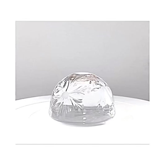 A clear cut engraved glass dome paperweight