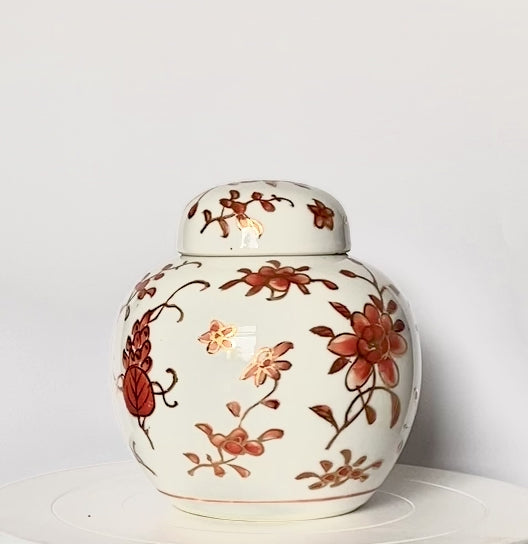 A Ginger jar. With gold gilding and orange flowery designs.