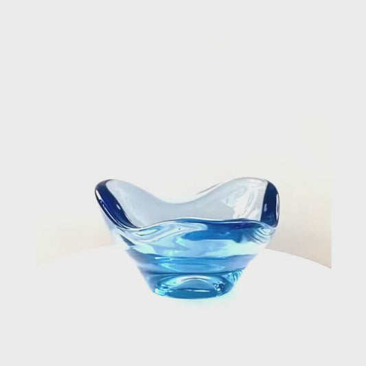 A triangular sky blue glass bowl.