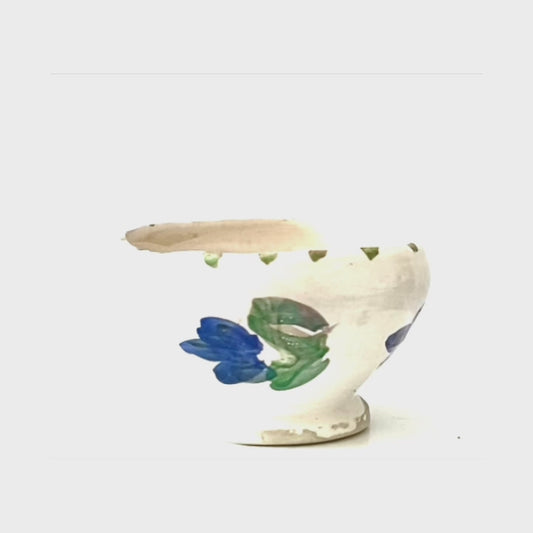 A crackled glaze earthenware ceramic pot with handpainted flowers.