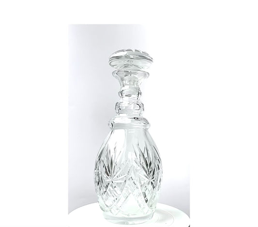 A cut crystal glass decanter.