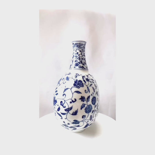 A blue and white porcelain oval jug, vase and candlestick .