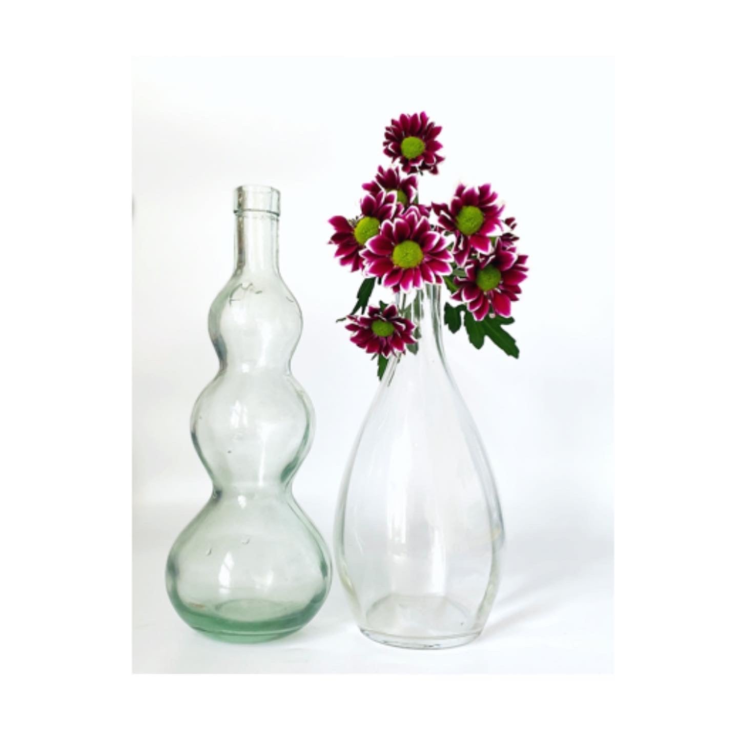 A pair of vintage glass vases and jug bottles.