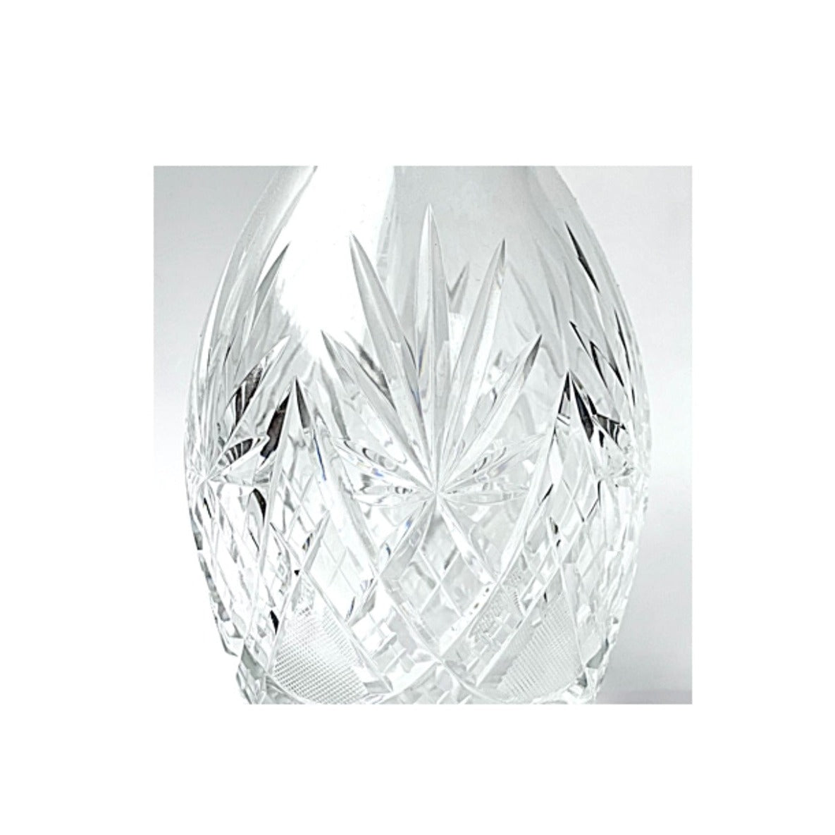 A cut crystal glass decanter.