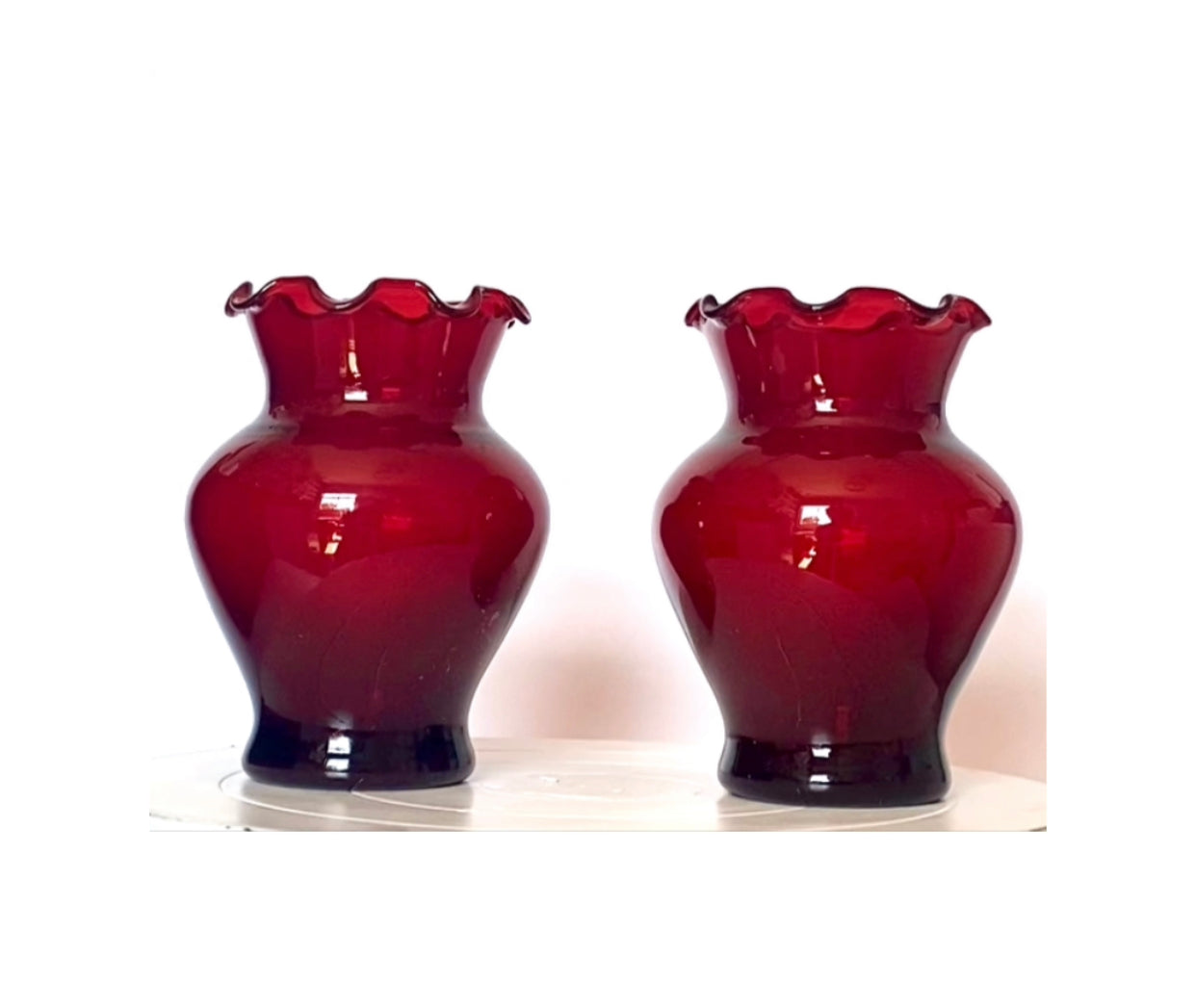 A pair of Cranberry red glass vases with a frill rim.