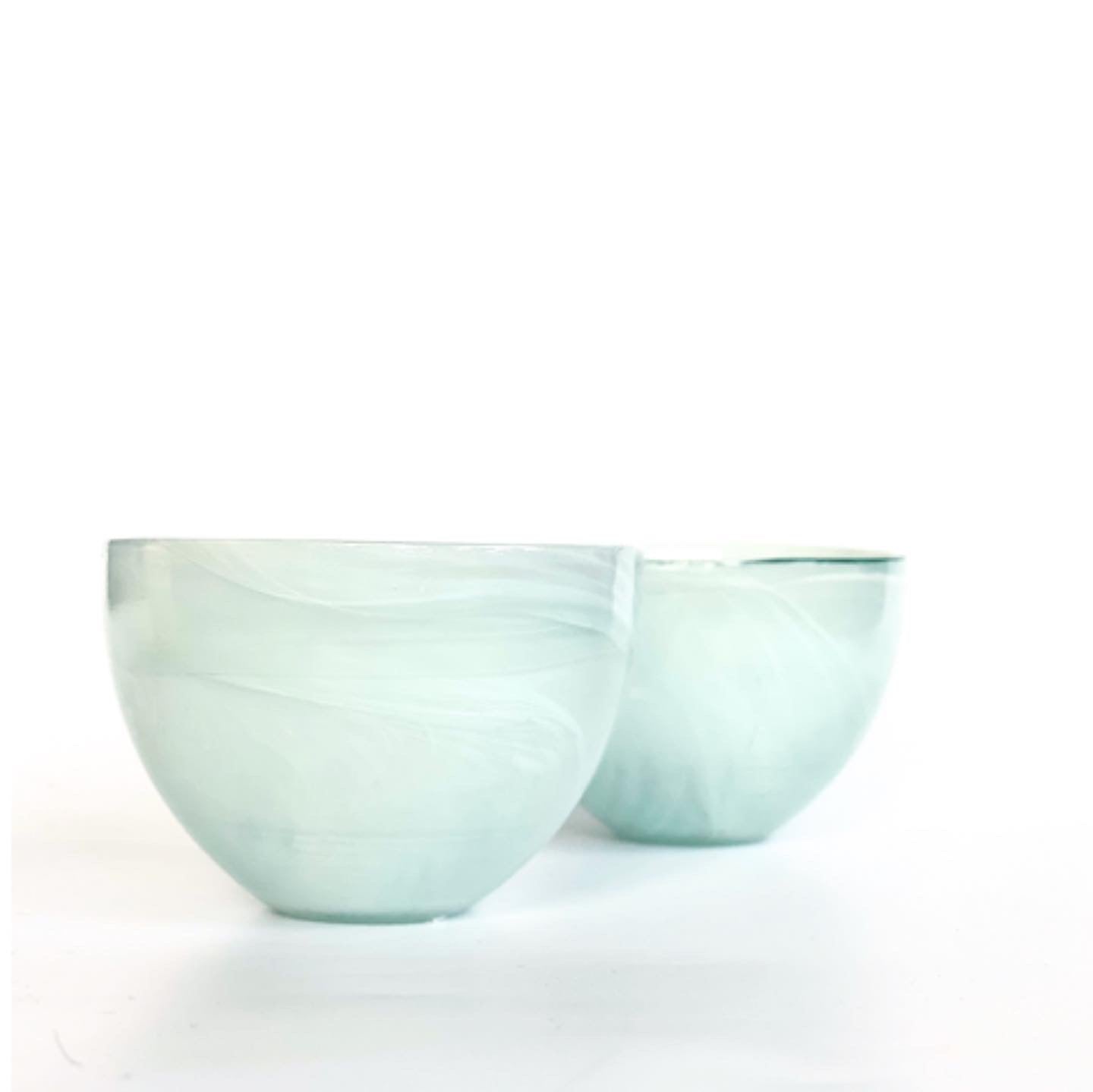 A pair of alabaster bowls in a soft mint green.