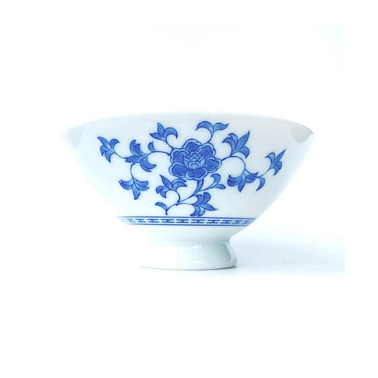 A collection of blue and white ceramic bowls and with one larger one .