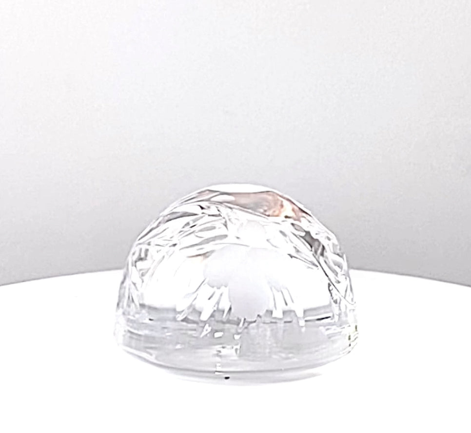 A clear cut engraved glass dome paperweight