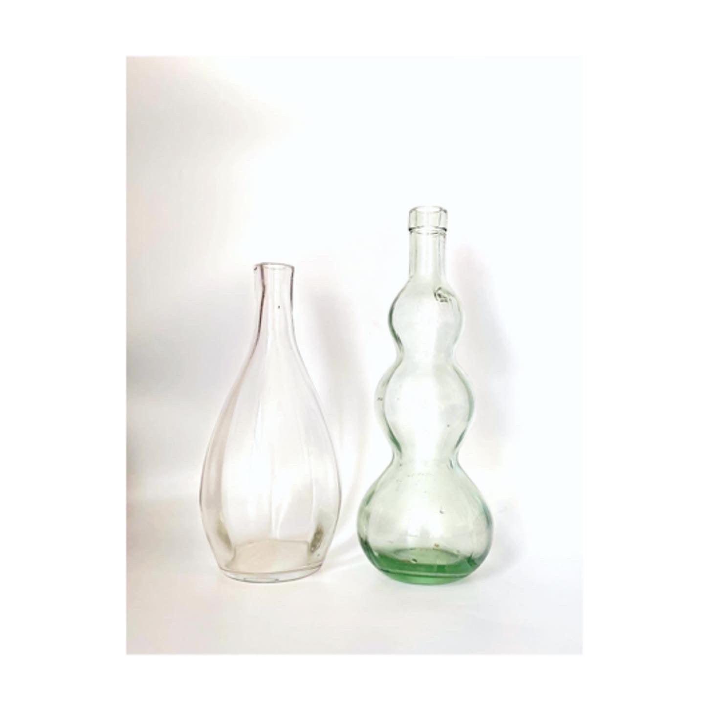 A pair of vintage glass vases and jug bottles.