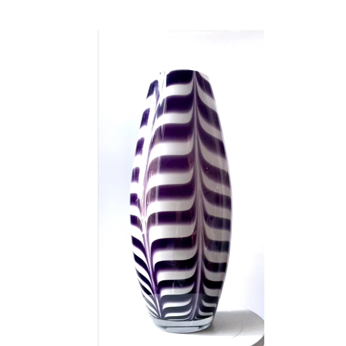 Studio art glass vase in a deep purple swirl.