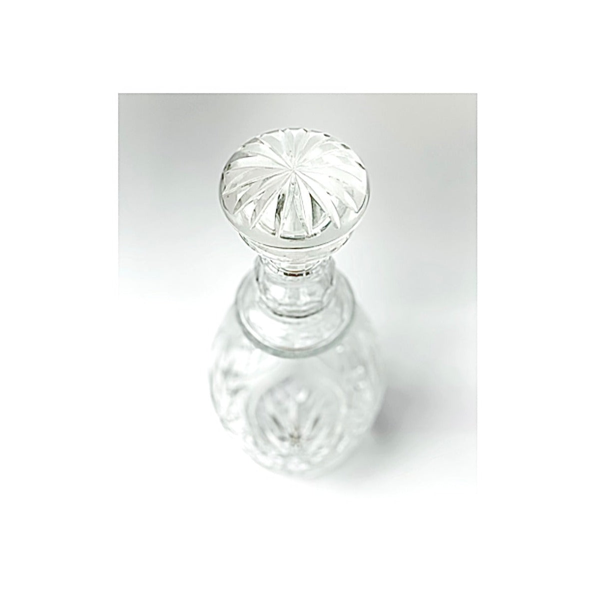 A cut crystal glass decanter.