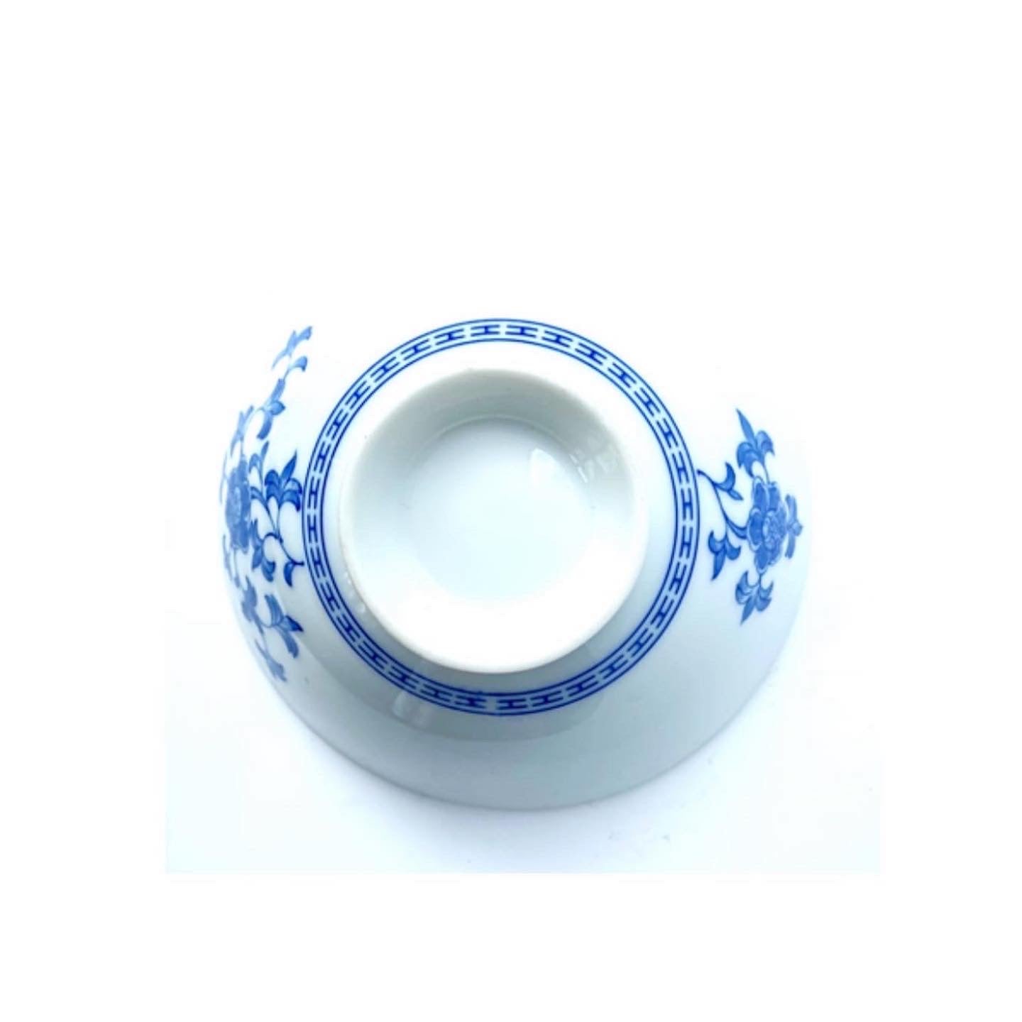 A collection of blue and white ceramic bowls and with one larger one .